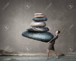 52850787-attractive-businesswoman-carrying-stack-of-stones-in-hands.jpg